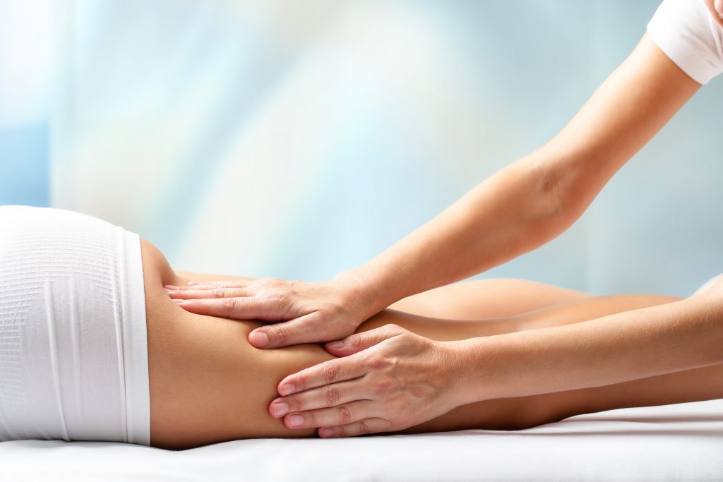 Woman receiving leg massage.